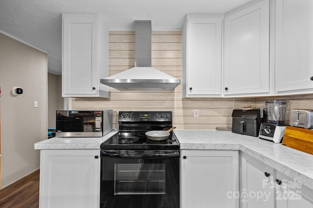 11 Pyrite Way, Asheville, NC 28806 - kitchen with black / electric stove, wall chimney exhaust hood, light countertops, and white cabinets