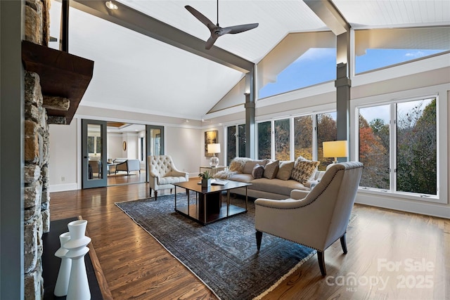 living area featuring high vaulted ceiling, wood finished floors, a ceiling fan, baseboards, and beam ceiling