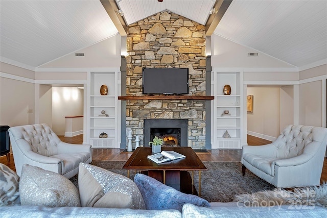 living room featuring built in shelves, visible vents, and wood finished floors