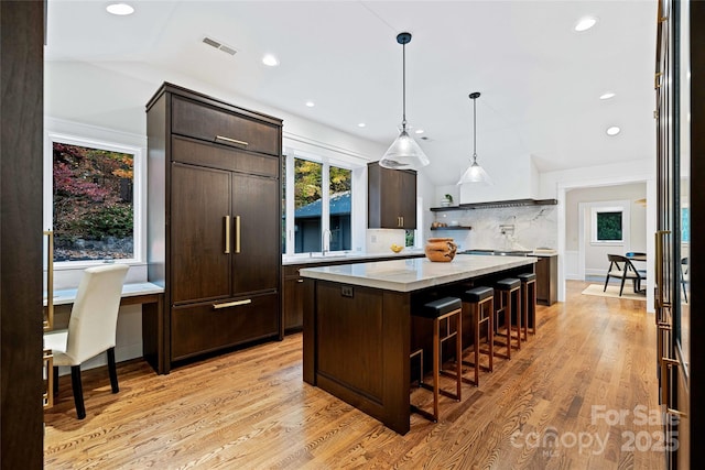 kitchen with light countertops, visible vents, and dark brown cabinets