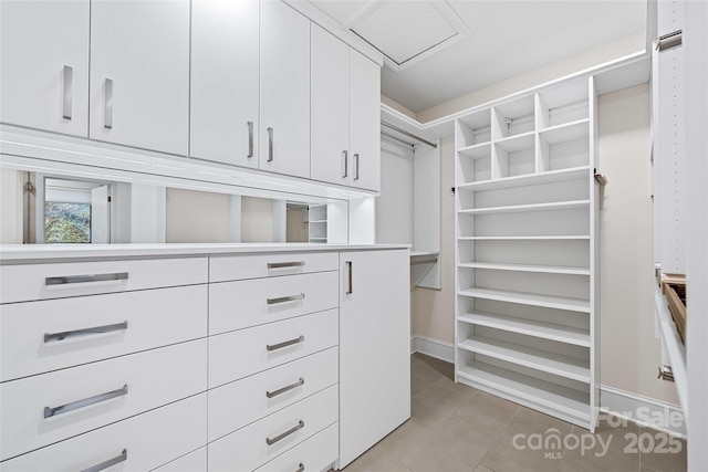 spacious closet featuring light tile patterned floors