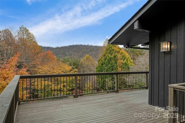 wooden deck with a forest view