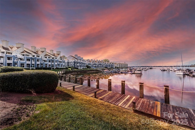 dock area featuring a yard and a water view