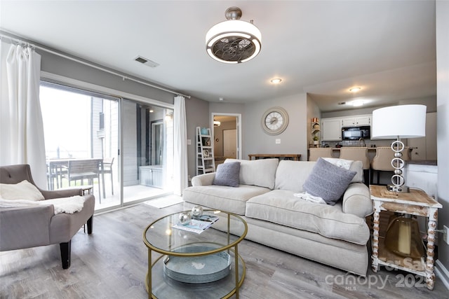 living room with visible vents and wood finished floors