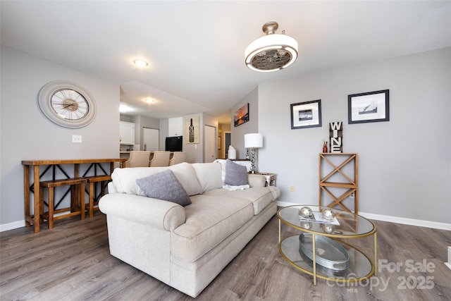 living area featuring wood finished floors and baseboards