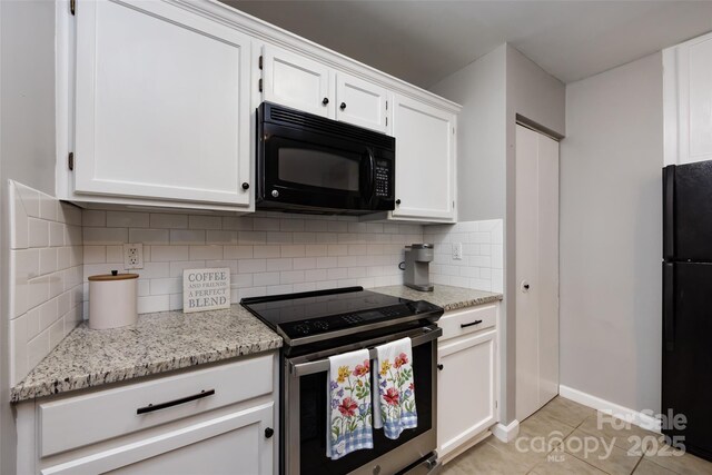 kitchen featuring tasteful backsplash, white cabinetry, black appliances, and light tile patterned floors