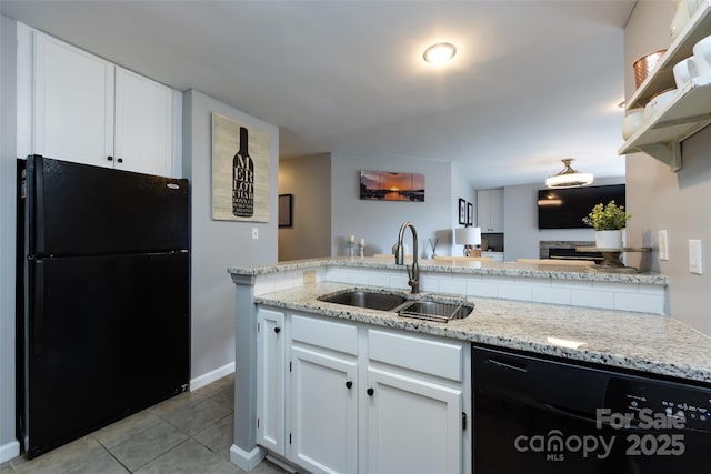 kitchen featuring light stone counters, light tile patterned flooring, a sink, white cabinetry, and black appliances