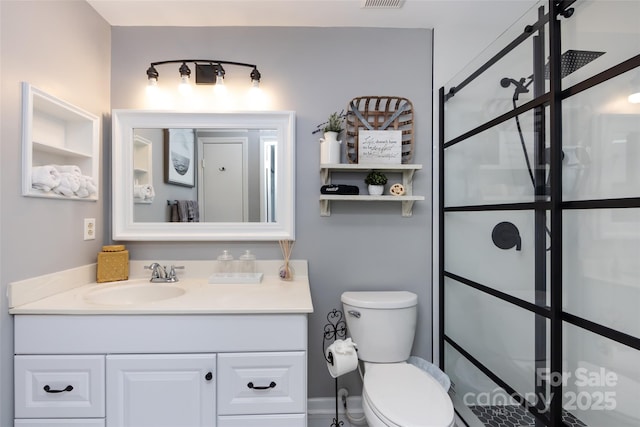 bathroom with toilet, visible vents, and vanity