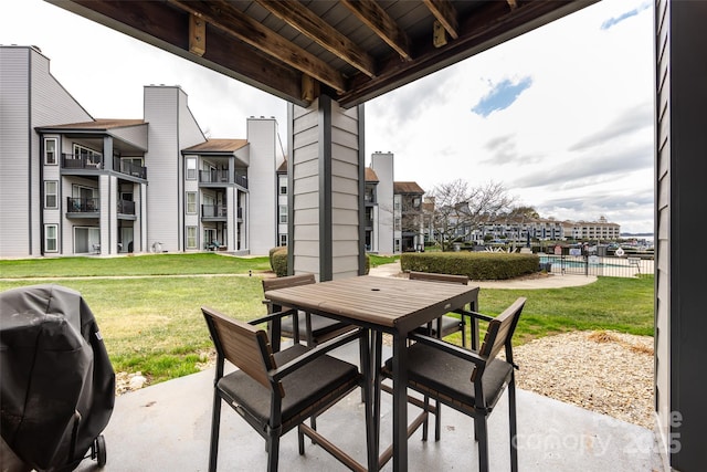 view of patio featuring a grill, a residential view, and outdoor dining space