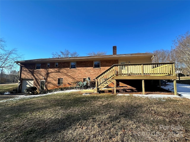 rear view of house featuring a garage, brick siding, stairs, a wooden deck, and a chimney