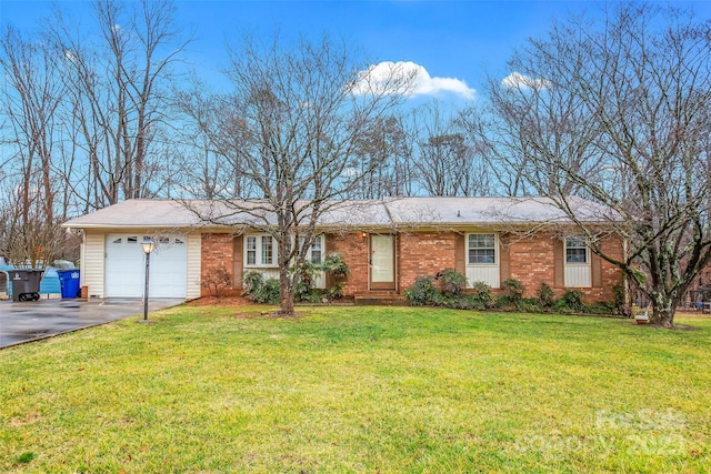 ranch-style home featuring a garage, a front yard, aphalt driveway, and brick siding