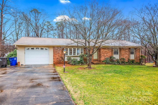 ranch-style home featuring driveway, brick siding, a garage, and a front yard