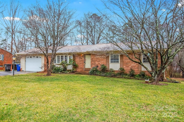 single story home with a garage, a front lawn, aphalt driveway, and brick siding