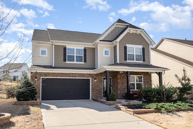 view of front facade featuring driveway, a garage, and board and batten siding