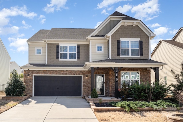 craftsman-style home featuring a garage, board and batten siding, and concrete driveway