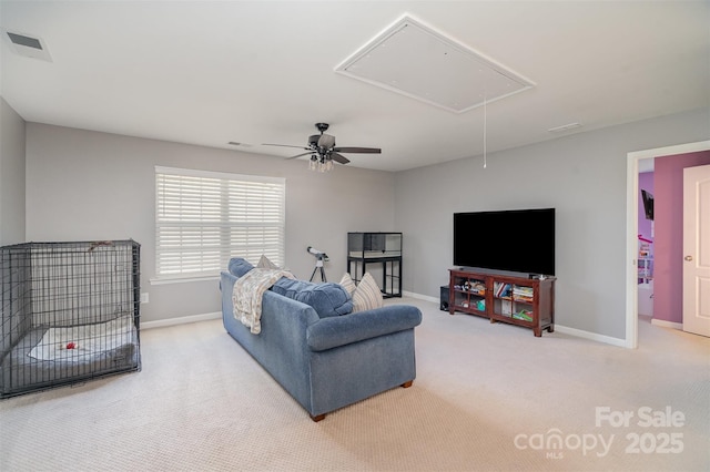 carpeted living room with attic access, visible vents, and baseboards