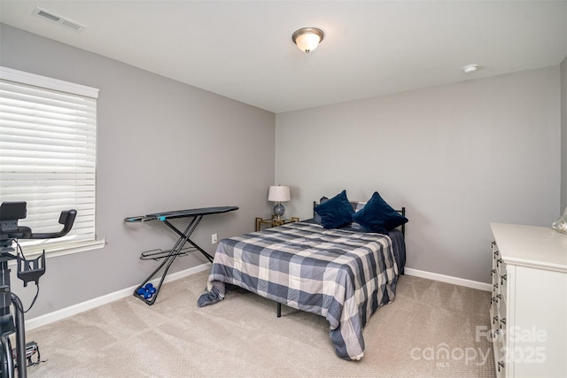 bedroom featuring light colored carpet, visible vents, and baseboards