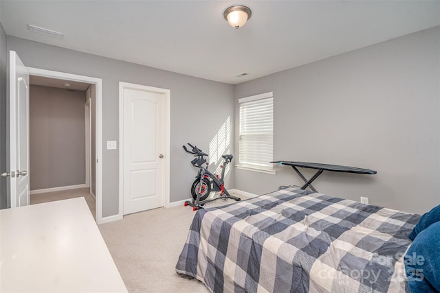 bedroom with visible vents, baseboards, and light colored carpet