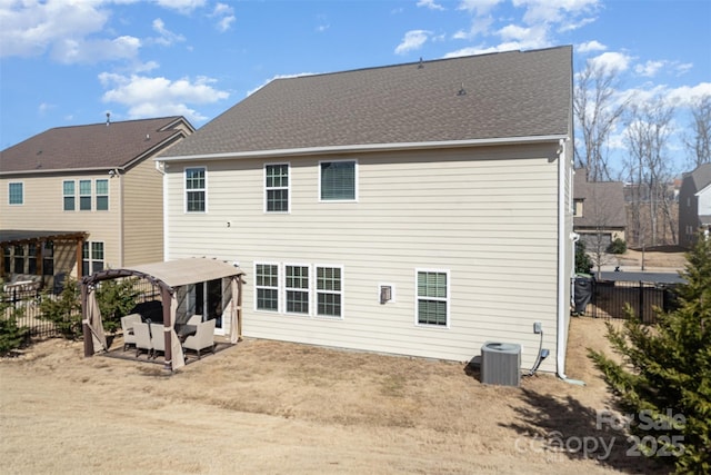 rear view of property with a patio, central air condition unit, a shingled roof, fence, and a pergola