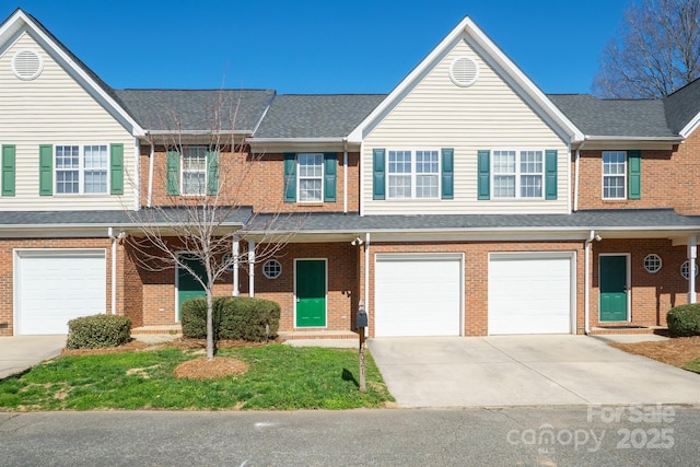 multi unit property with a garage, concrete driveway, brick siding, and a shingled roof