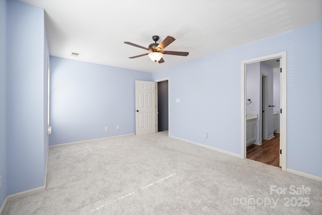 unfurnished bedroom featuring carpet, connected bathroom, visible vents, and baseboards