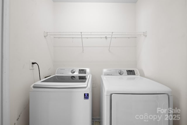 clothes washing area featuring laundry area and washing machine and clothes dryer