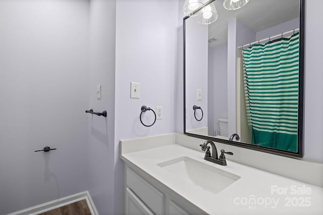 bathroom with vanity and baseboards