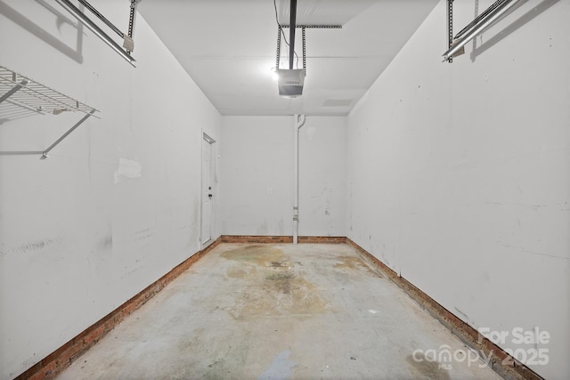 garage featuring baseboards and a garage door opener