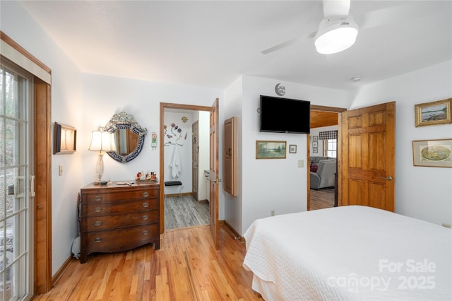 bedroom with baseboards, a ceiling fan, and light wood-style floors