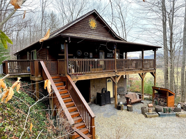 view of front of house featuring stairway and a wooden deck