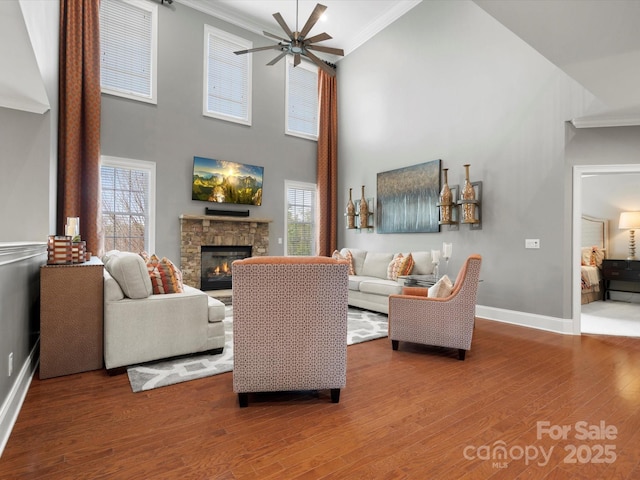 living area featuring ornamental molding, a wealth of natural light, and wood finished floors