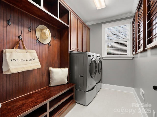 washroom with visible vents, baseboards, ornamental molding, independent washer and dryer, and cabinet space