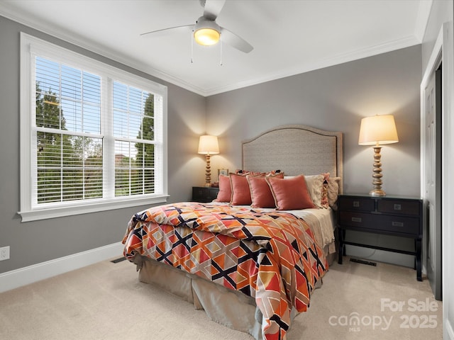 bedroom with crown molding, carpet floors, baseboards, and a ceiling fan