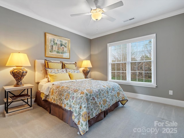carpeted bedroom featuring crown molding, baseboards, a ceiling fan, and visible vents