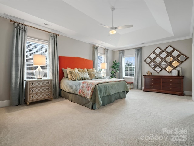 bedroom featuring visible vents, a raised ceiling, carpet flooring, and a ceiling fan