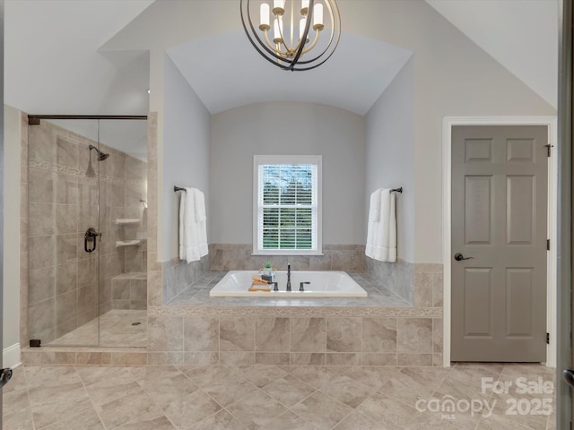 bathroom featuring a notable chandelier, a bath, vaulted ceiling, and a stall shower