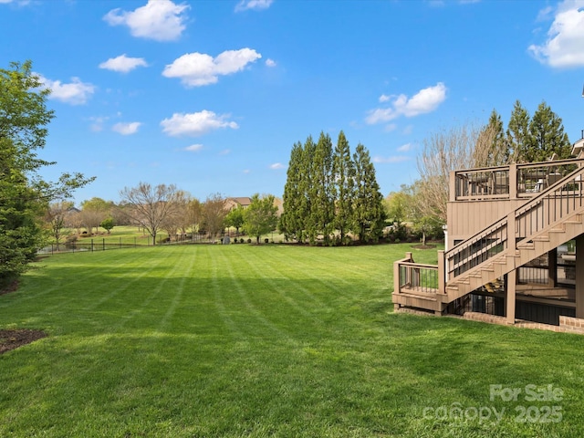 view of yard featuring stairs and a deck