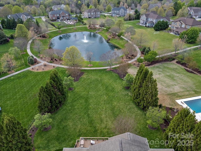 drone / aerial view with a water view and a residential view