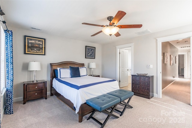 bedroom featuring baseboards, visible vents, and light colored carpet