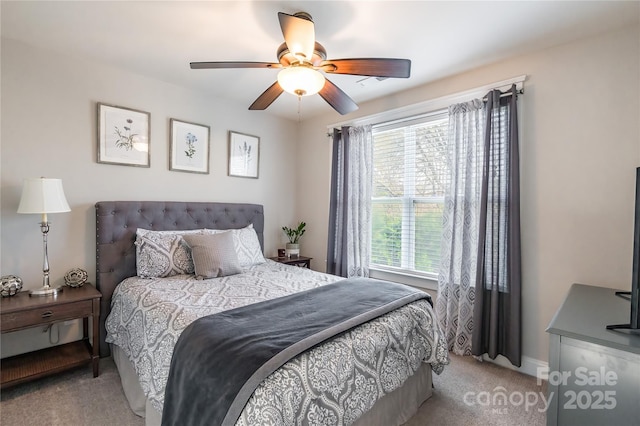 bedroom featuring light colored carpet, ceiling fan, and baseboards