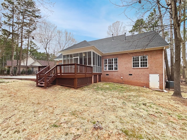 back of property featuring brick siding, roof with shingles, a sunroom, crawl space, and fence