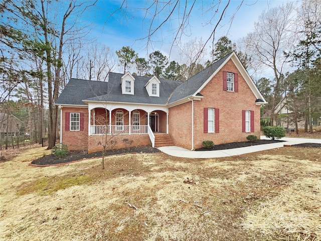 view of front of property with covered porch and brick siding