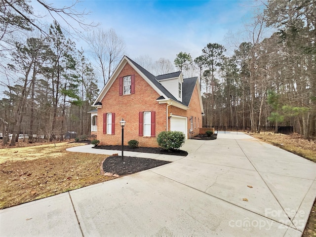 view of front facade featuring driveway and brick siding