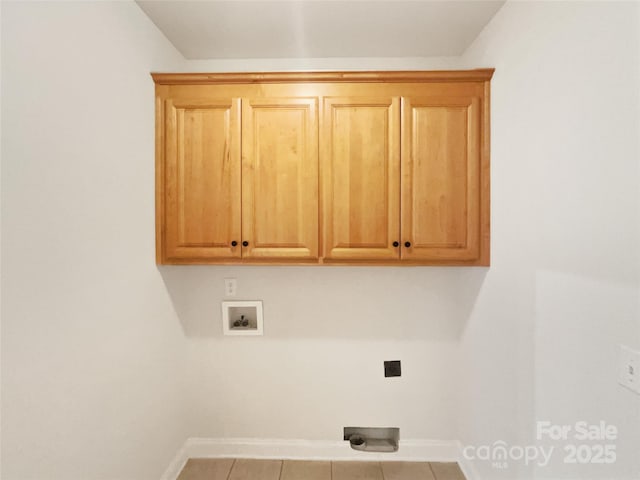 laundry room featuring cabinet space, baseboards, tile patterned floors, hookup for a washing machine, and hookup for an electric dryer