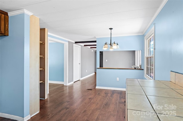 interior space with a chandelier, ornamental molding, baseboards, and wood finished floors