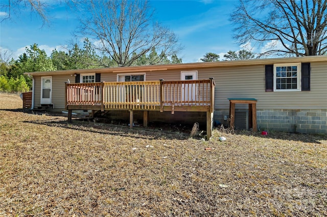 back of house featuring a wooden deck