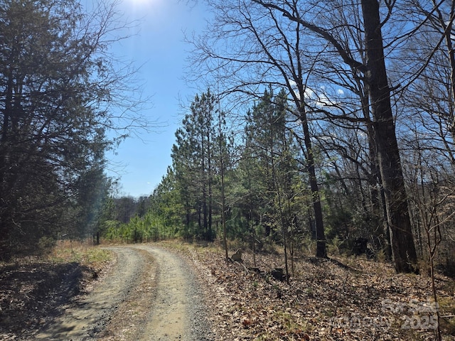 view of road featuring a forest view