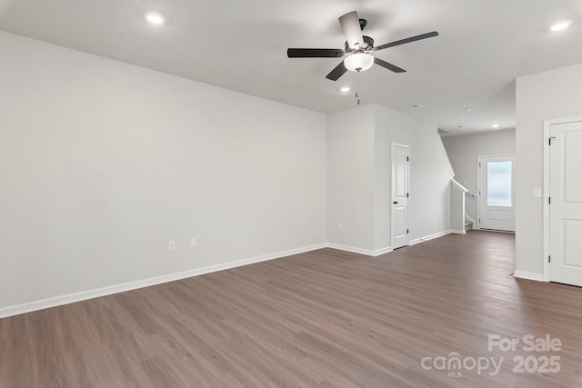 empty room featuring ceiling fan, baseboards, wood finished floors, and recessed lighting