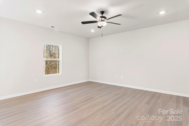 spare room with recessed lighting, ceiling fan, light wood-style flooring, and baseboards