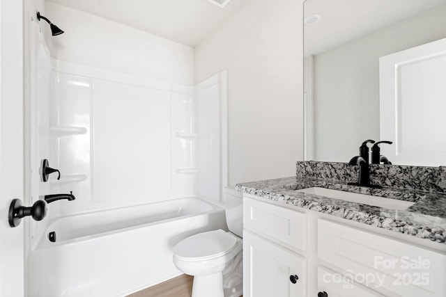 full bath featuring bathtub / shower combination, vanity, toilet, and wood finished floors